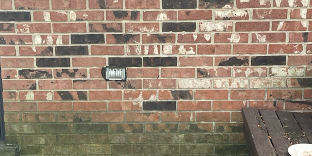 Brick by the sliding door before power washing